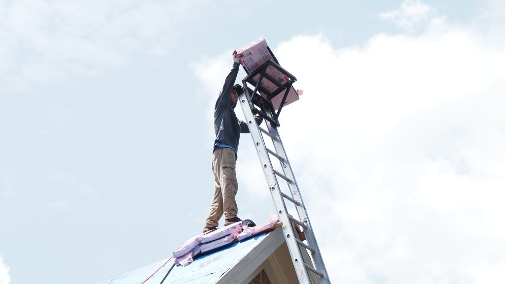 shingles being brought to top of roof